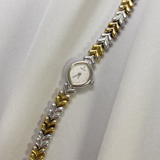 Seiko petite ladies watch Wristwatch with a decorative metal band on a white fabric background