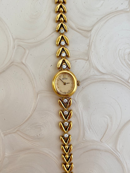 Seiko Ladies Gold Tennis Bracelet Watch with Diamond Accents and Champagne Dial