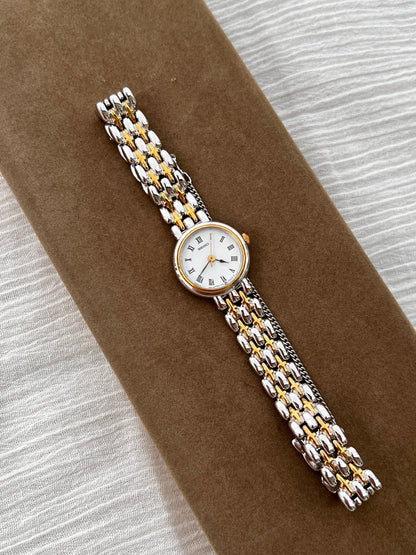 Seiko vintage ladies dress watch with two-tone gold and silver bracelet, white Roman numeral dial, and spade hands – classic quartz timepiece from Gilded Hour NZ.