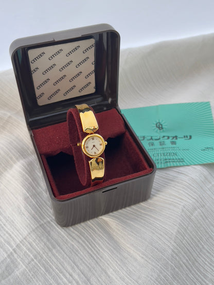 Vintage Citizen Chère women’s gold bangle watch with white dial and Roman numeral, styled on wrist with a crystal tennis bracelet