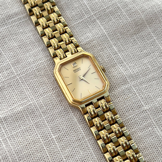 Vintage Seiko gold tank watch with rectangular case and cream dial