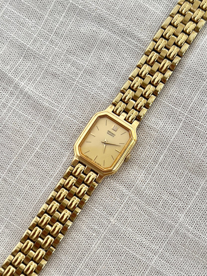 Vintage Seiko gold tank watch with rectangular case and cream dial