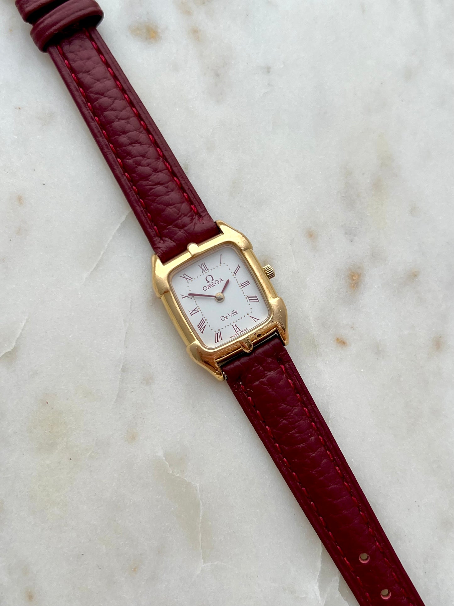 Omega De Ville Gold Women’s Watch with Burgundy Roman Numerals