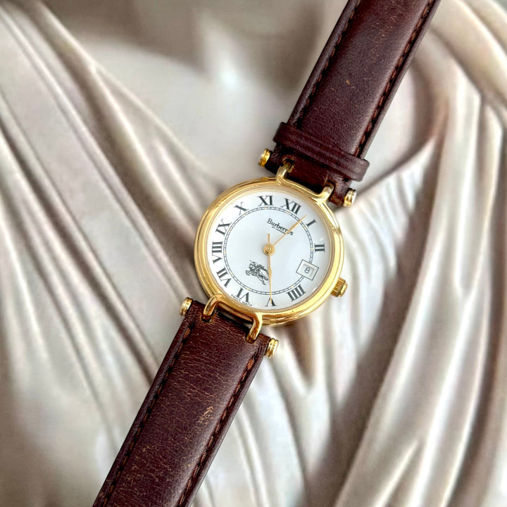 Burberrys gold women's watch with sculpted loop lugs