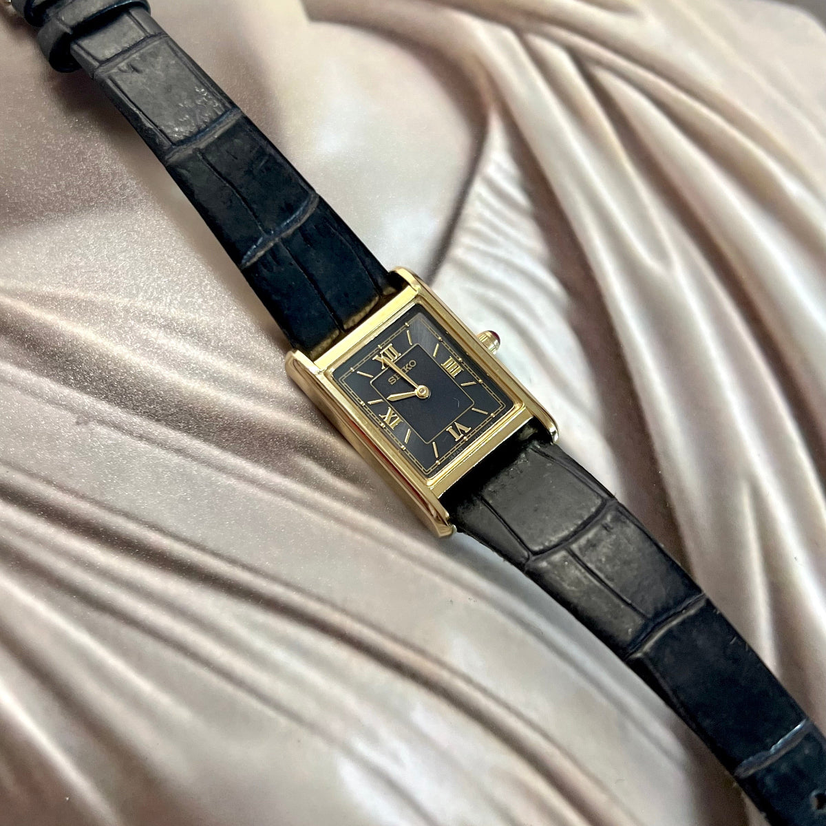 Seiko x Nano Universe black Roman numeral women’s watch with gold rectangular case