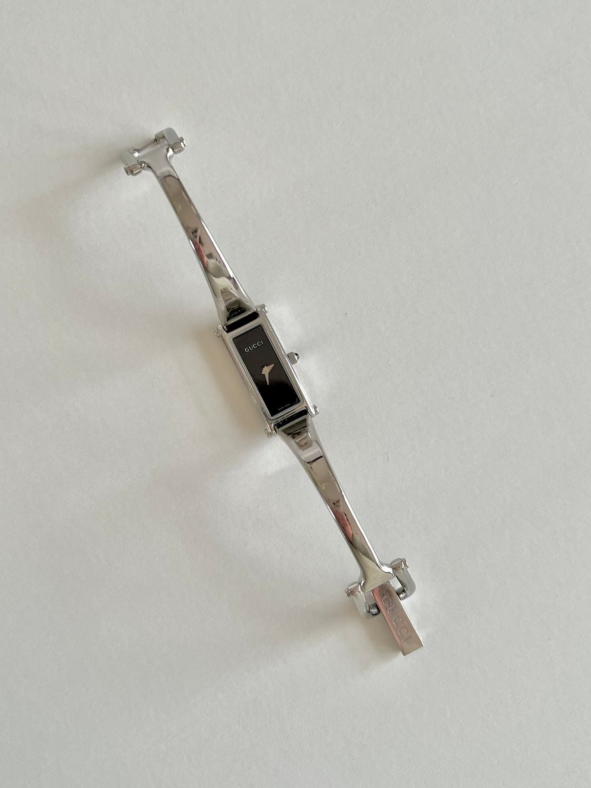 Gucci 1500L Silver Bangle Women's Watch Black Dial, angled view of a vintage women's watch at Gilded Hour.