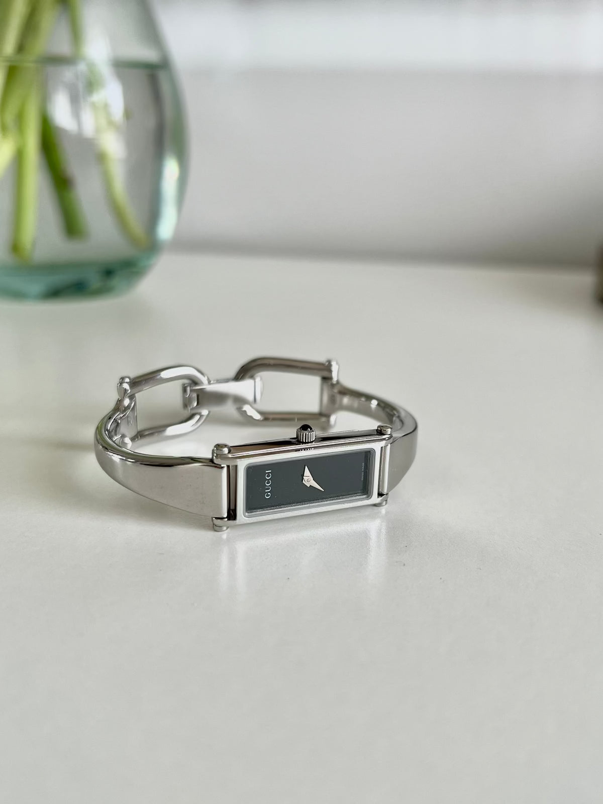 Gucci 1500L Silver Bangle Women's Watch Black Dial (Small), wrist shot of a vintage women's watch at Gilded Hour.