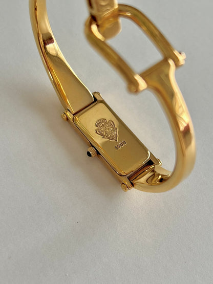 Gucci 1500 Gold Bangle Women’s Watch Mother of Pearl Dial, wrist shot of a vintage women's watch at Gilded Hour.