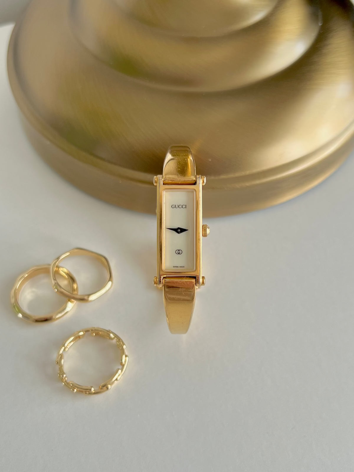 Gucci 1500 Gold Bangle Women’s Watch Ivory Dial, angled view of a vintage women's watch at Gilded Hour.