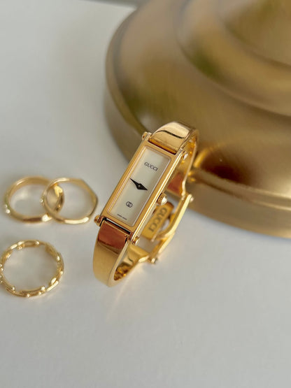 Gucci 1500 Gold Bangle Women’s Watch Ivory Dial, wrist shot of a vintage women's watch at Gilded Hour.
