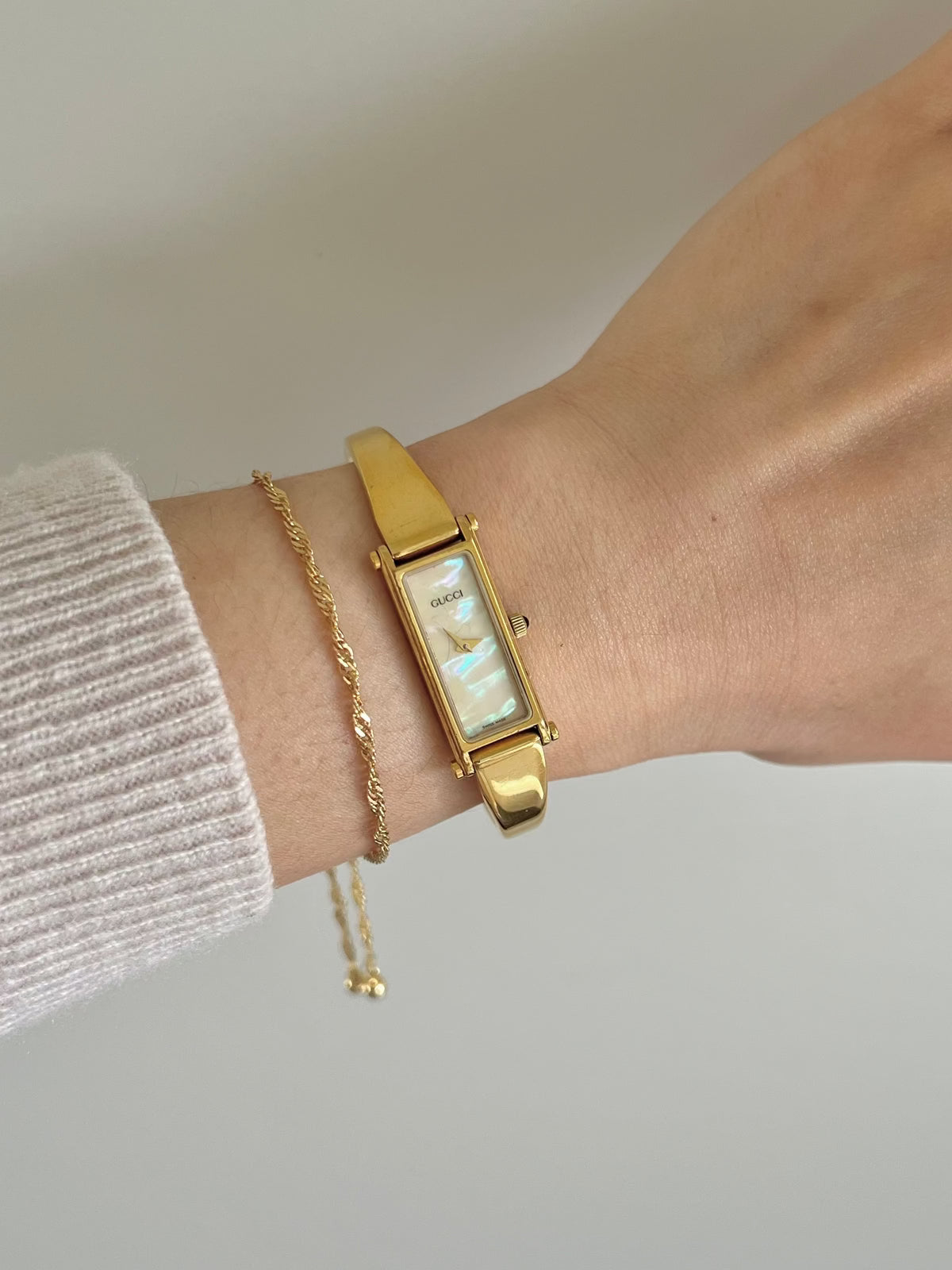 Gucci 1500 Gold Bangle Women’s Watch Mother of Pearl Dial, dial close up of a vintage women's watch at Gilded Hour.