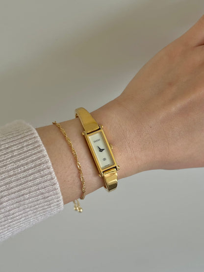 Gucci 1500 Gold Bangle Women’s Watch Ivory Dial, dial close up of a vintage women's watch at Gilded Hour.