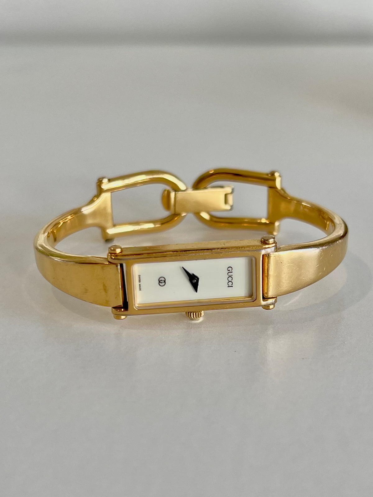 Gucci 1500 Gold Bangle Women’s Watch Ivory Dial, case profile of a vintage women's watch at Gilded Hour.