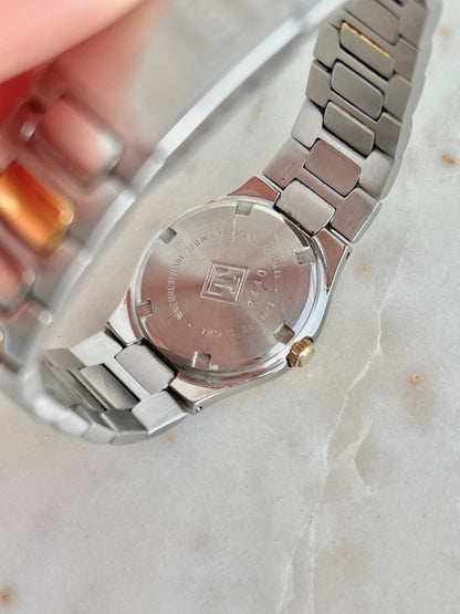Tissot P440 White Roman Date Two Tone Watch: p440 case-back marking held close.