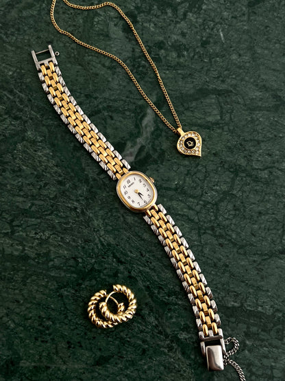 Gold vintage Dior heart pendant necklace with diamond detailing styled on green marble, and Seiko women's watch feminine jewellery aesthetic photographed by The Gilded Hour NZ.