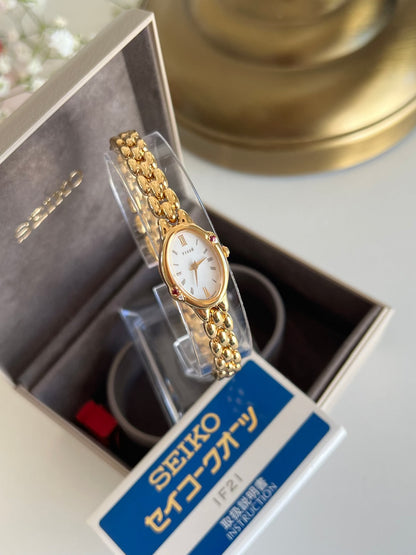 Seiko Tisse Gold Bead Bracelet Women's Watch with Encrusted Ruby & Diamond, angled view of a vintage women's watch at Gilded Hour.