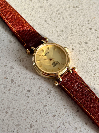 Burberrys Gold Lady Watch with Sculpted Loop Lugs and Champagne Dial 24mm Diameter