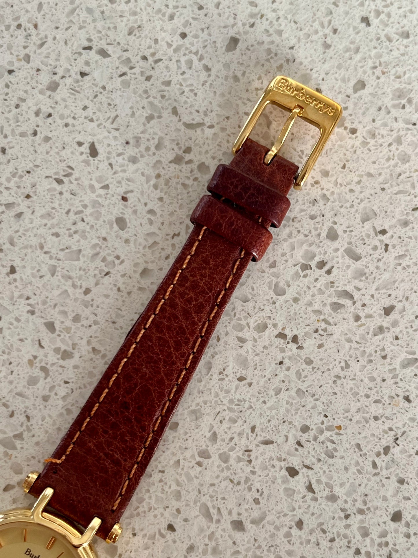 Burberrys Gold Lady Watch with Sculpted Loop Lugs and Champagne Dial 24mm Diameter