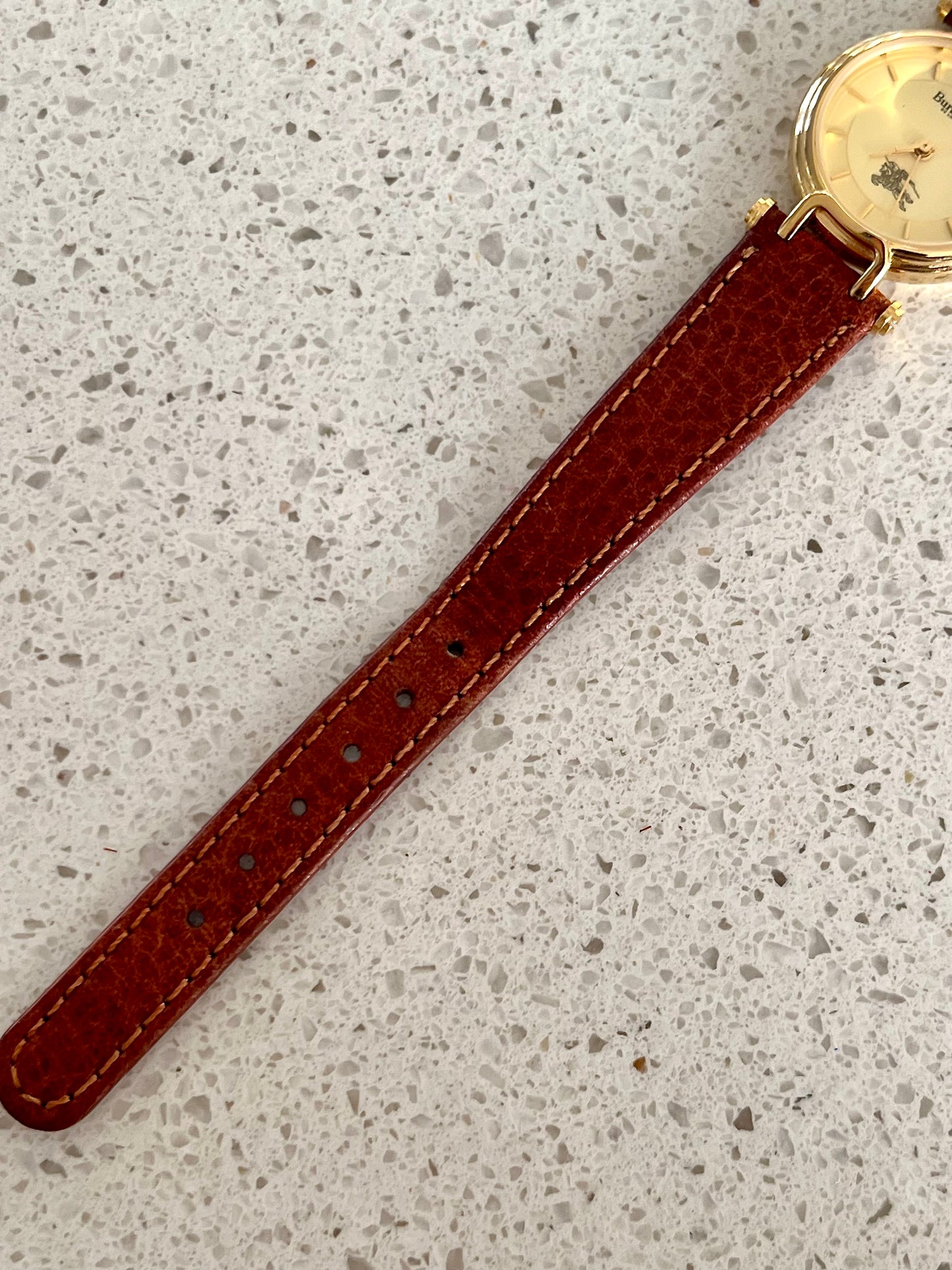 Burberrys Gold Lady Watch with Sculpted Loop Lugs and Champagne Dial 24mm Diameter