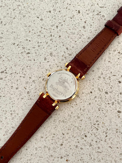 Burberrys Gold Lady Watch with Sculpted Loop Lugs and Champagne Dial 24mm Diameter