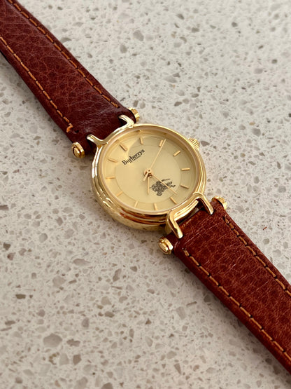 Burberrys Gold Lady Watch with Sculpted Loop Lugs and Champagne Dial 24mm Diameter
