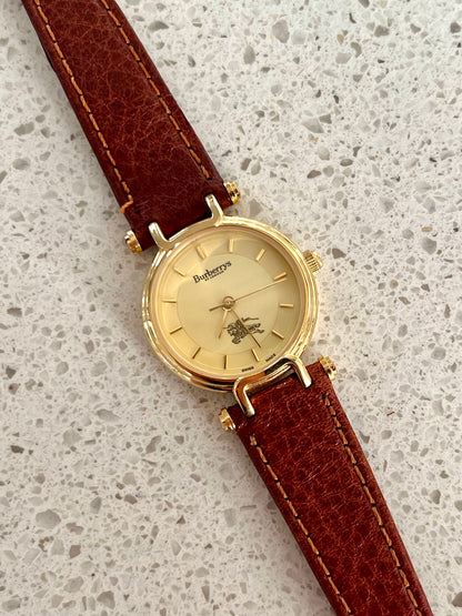 Burberrys Gold Lady Watch with Sculpted Loop Lugs and Champagne Dial 24mm Diameter