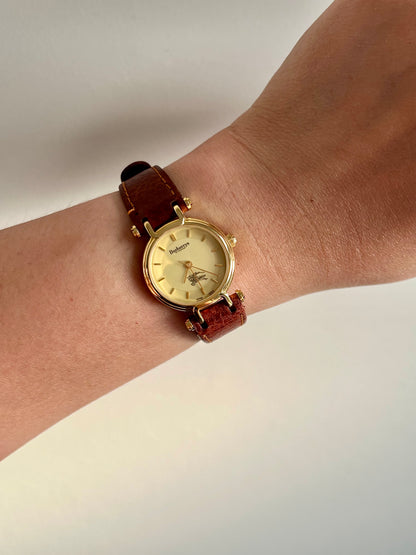 Burberrys Gold Lady Watch with Sculpted Loop Lugs and Champagne Dial 24mm Diameter