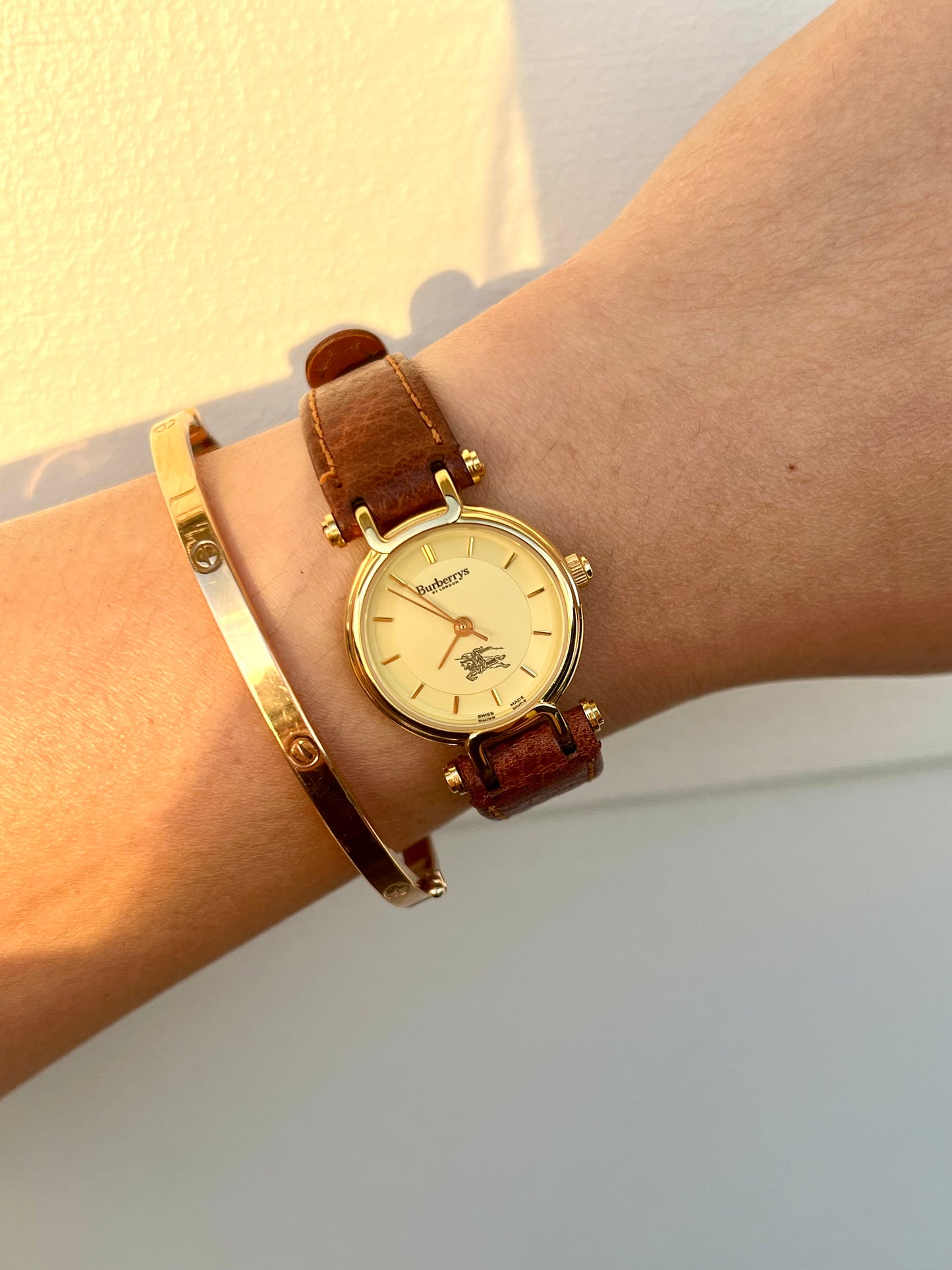 Burberrys Gold Lady Watch with Sculpted Loop Lugs and Champagne Dial 24mm Diameter