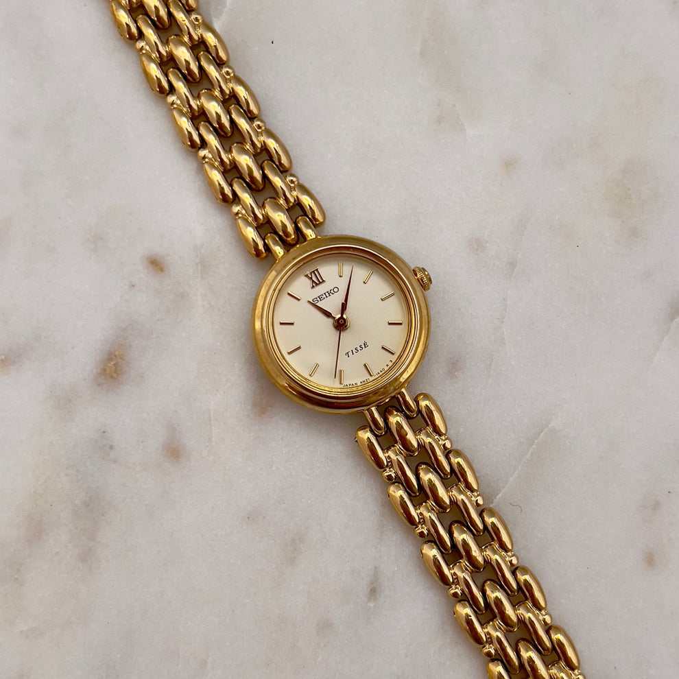 Round gold toned Seiko Tisse with rice style bracelet
