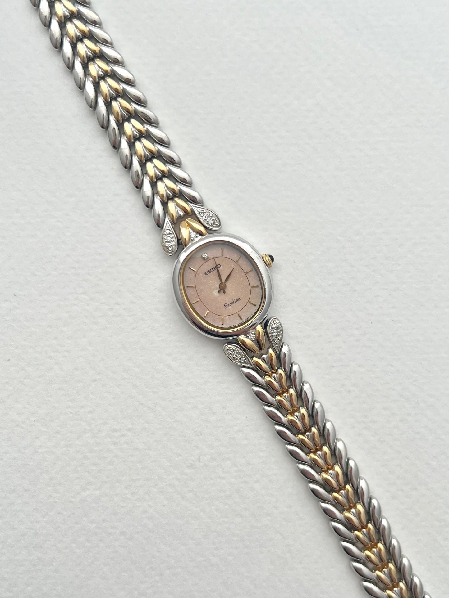 Seiko Exceline Ladies Oval Watch with Stardust Salmon Dial and Diamond Leaf Bracelet