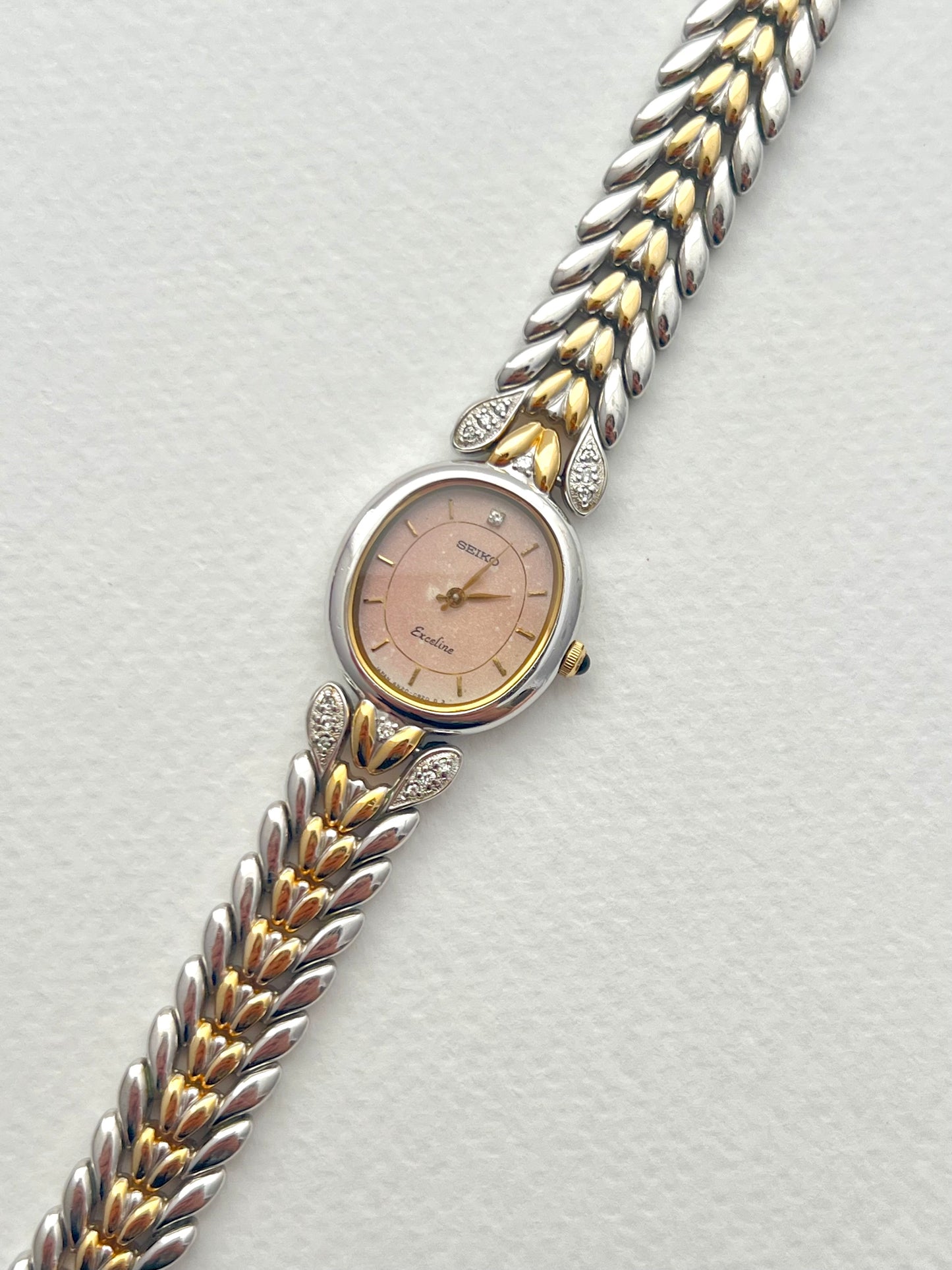 Seiko Exceline Ladies Oval Watch with Stardust Salmon Dial and Diamond Leaf Bracelet