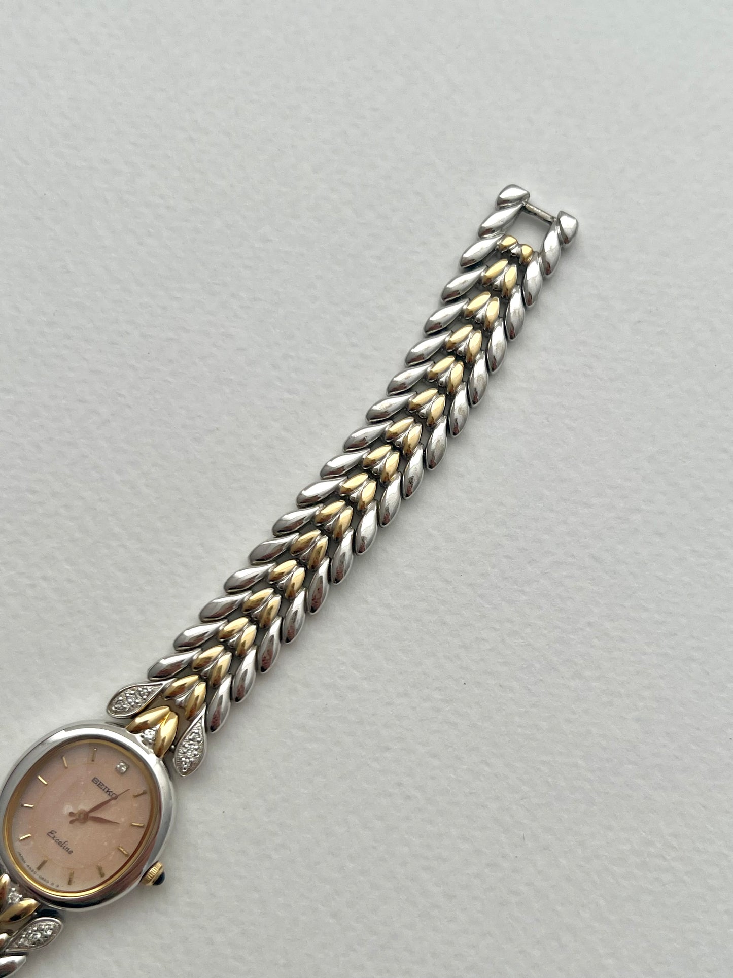 Seiko Exceline Ladies Oval Watch with Stardust Salmon Dial and Diamond Leaf Bracelet