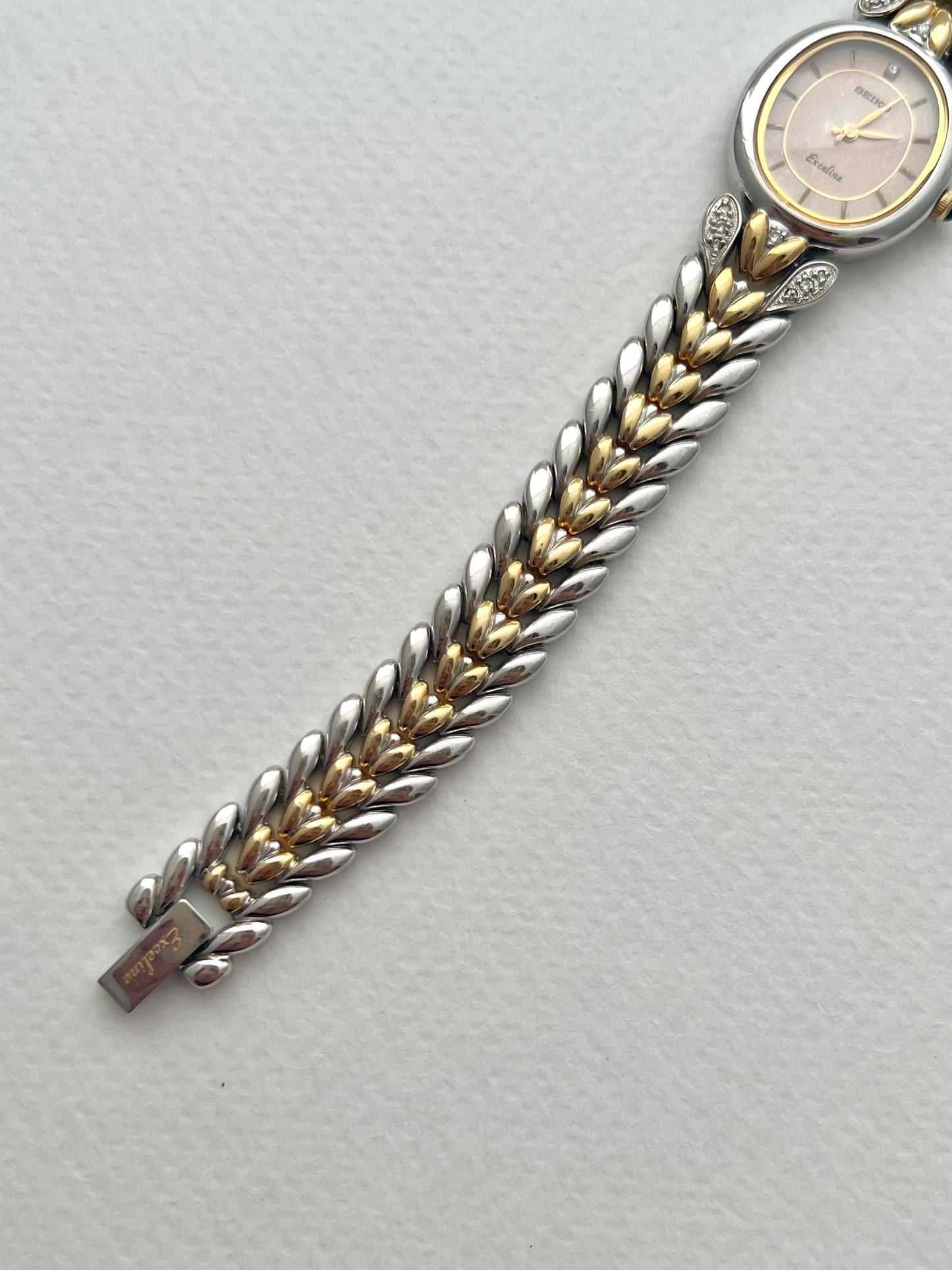 Seiko Exceline Ladies Oval Watch with Stardust Salmon Dial and Diamond Leaf Bracelet