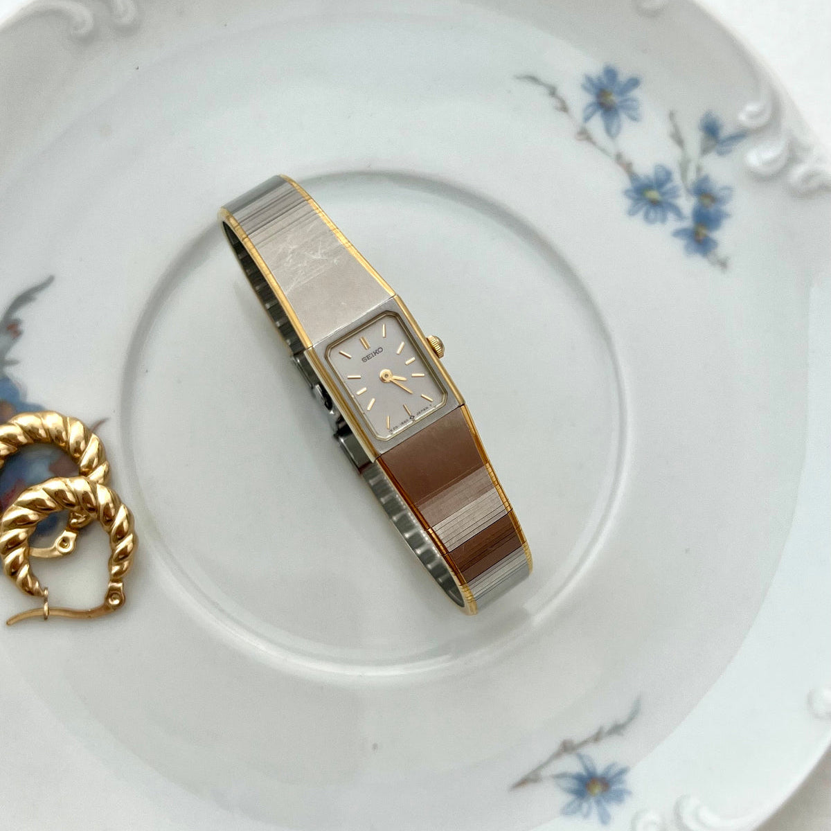Vintage Seiko Ladies watch on a decorative plate with floral patterns