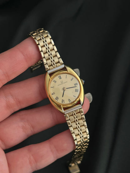 Universal Geneve C Case Roman Dial Gold Watch: dial held in hand.