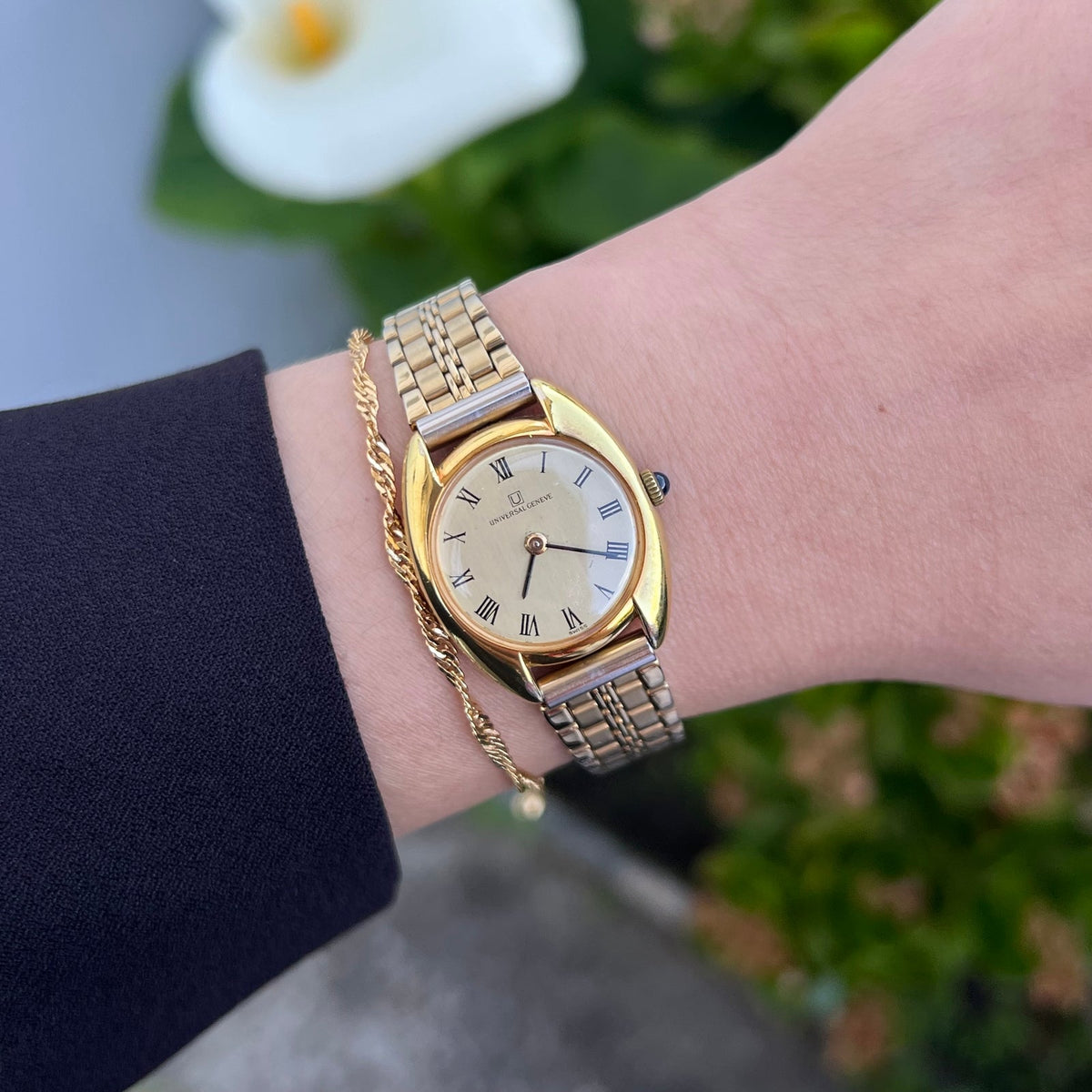 Universal Geneve C Case Roman Dial Gold Watch: roman dial and C case worn on wrist.