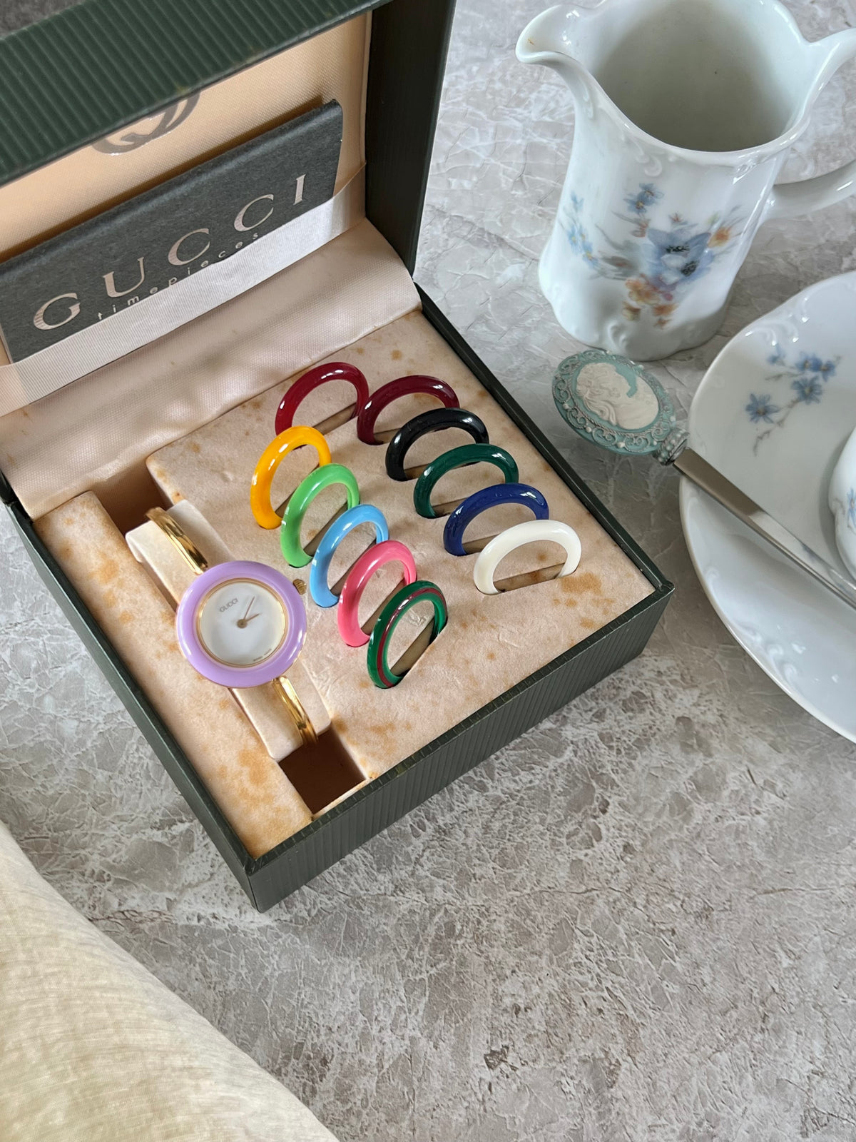 Gucci 1100L Interchangeable Bezel Women’s Watch Full Set of 12, angled view of a vintage women's watch at Gilded Hour.