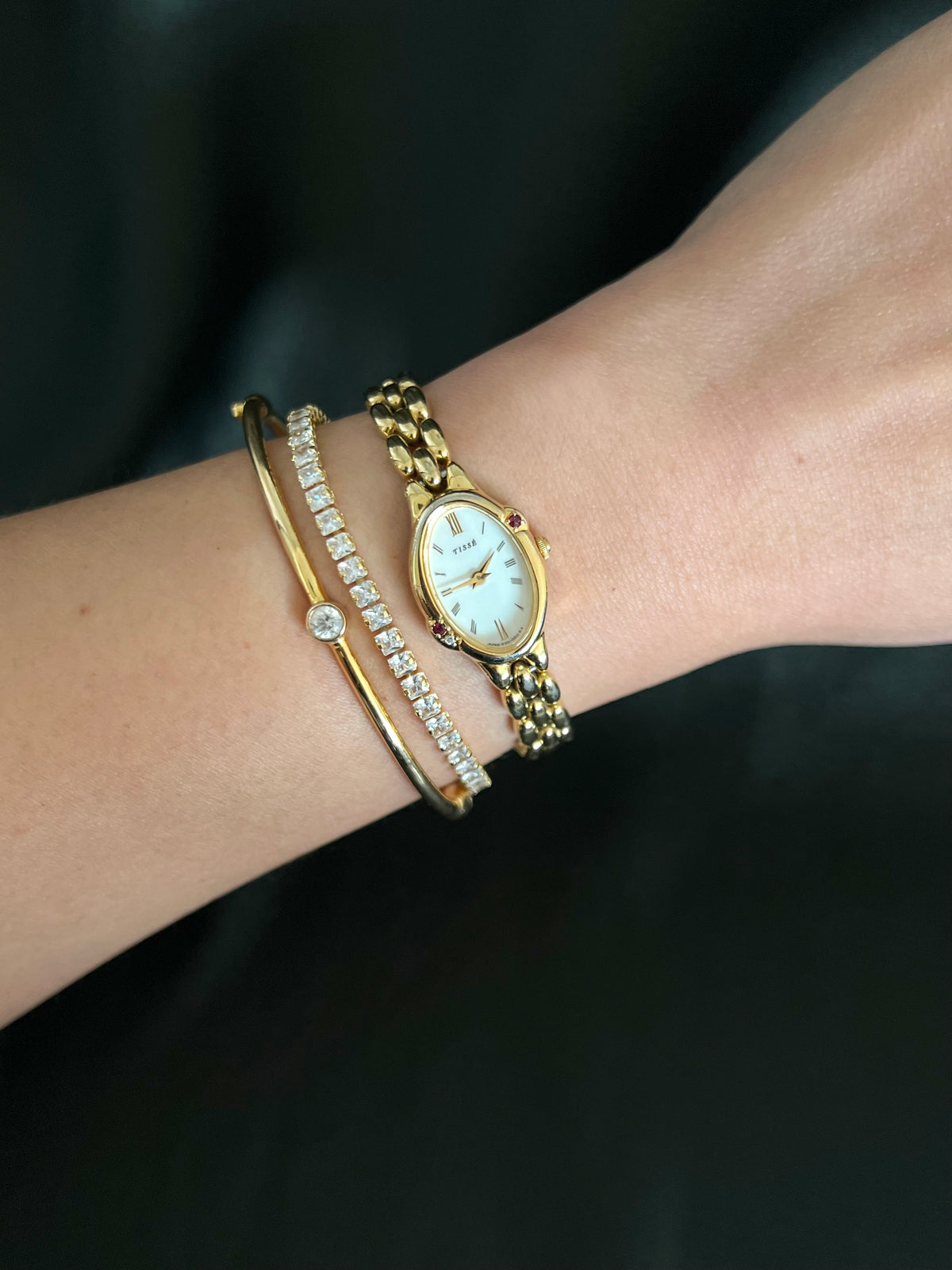 Gold Seiko Tisse bracelet watch worn with fine jewellery