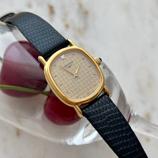 Longines Gold women's watch with set diamond,  black strap on a white background