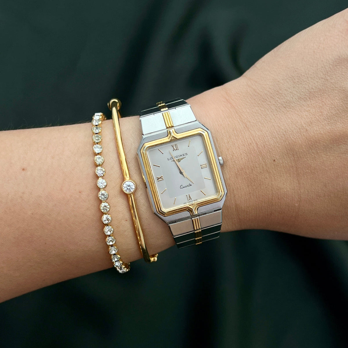 Longines Silver and gold women's watch in NZ on a wrist with a dark background