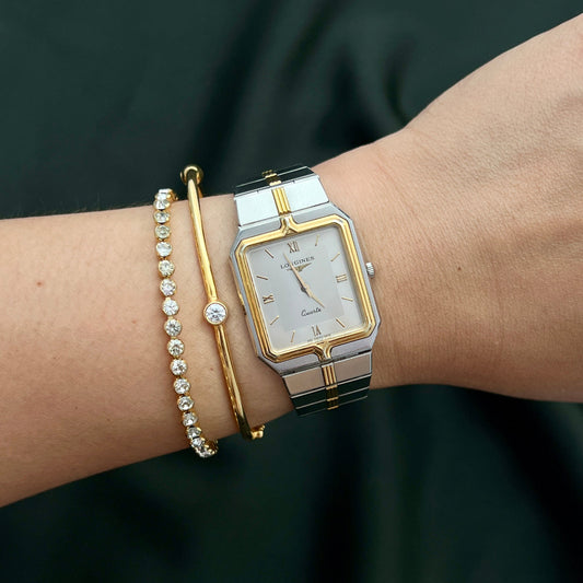 Longines Silver and gold women's watch in NZ on a wrist with a dark background