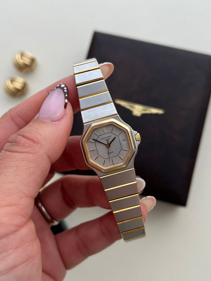 Vintage Longines two tone women's watch featuring an octagonal case, silver textured dial, integrated bracelet and date window at 3 o'clock