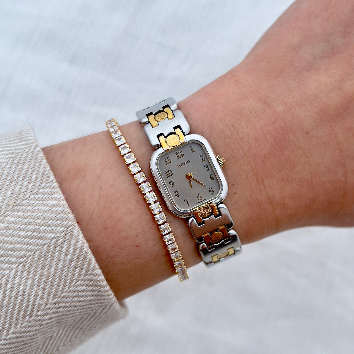 Close-up of a wrist wearing a Rado Ladies watch with a white background