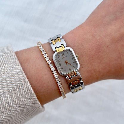 Close-up of a wrist wearing a Rado Ladies watch with a white background
