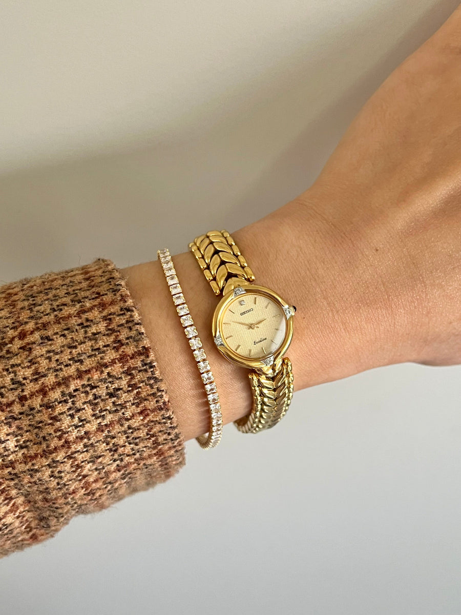 Gold Seiko Exceline diamond bracelet watch on wrist