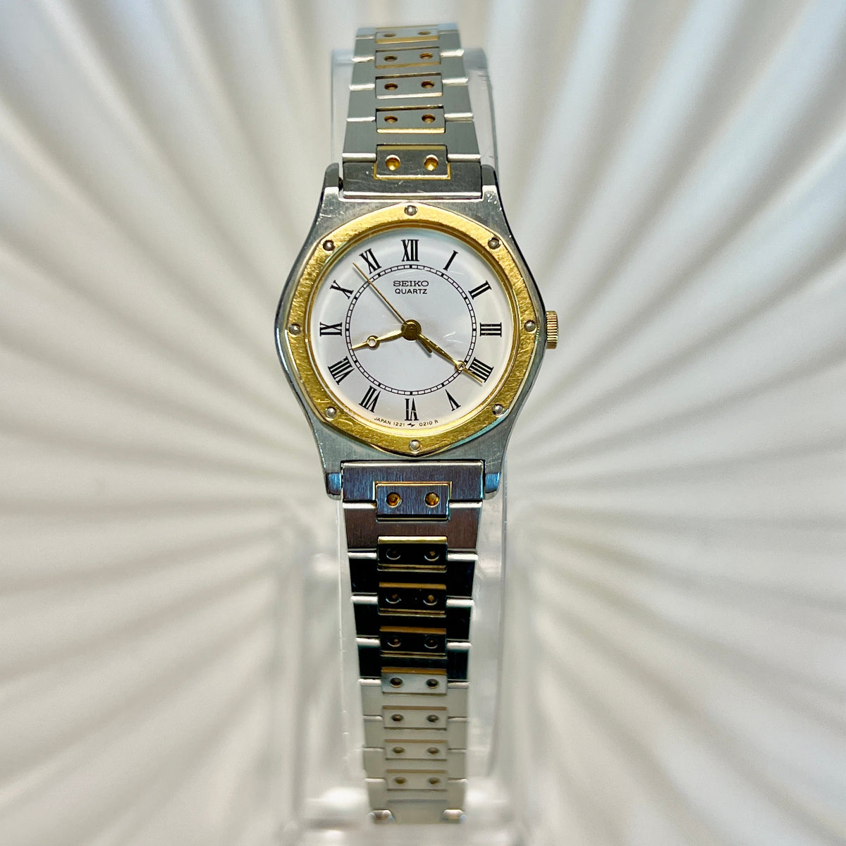 Seiko Two-tone watch with silver and gold band on a textured white background