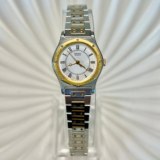 Seiko Two-tone watch with silver and gold band on a textured white background