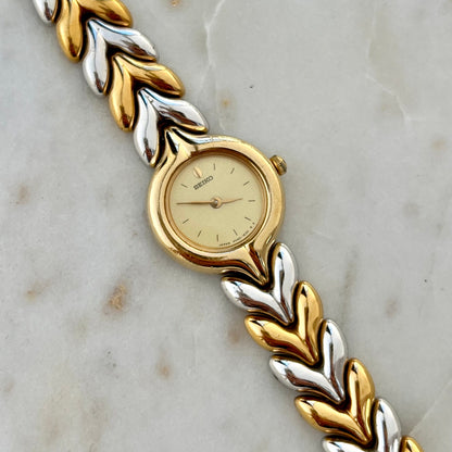 Seiko Gold and silver braided Women's watch on a marble surface