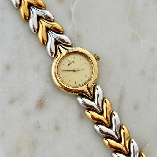 Seiko Gold and silver braided Women's watch on a marble surface