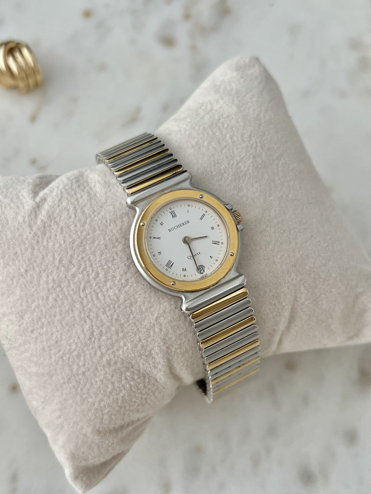 Bucherer 256.510 Roman dial two tone women’s watch showing the gold tone bezel, date window and integrated bracelet